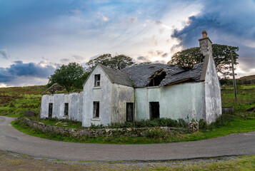 Old, dilapidated house on the Isle of Skye, its roof caved in and walls crumbling, under a dramatic, cloudy sky © Philip