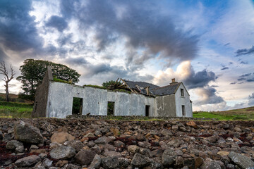 Old, dilapidated house on the Isle of Skye, its roof caved in and walls crumbling, under a dramatic, cloudy sky © Philip