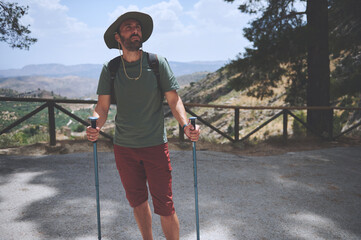 Outdoor Enthusiast Enjoying a Mountain Hike with Trekking Poles on a Beautiful Day