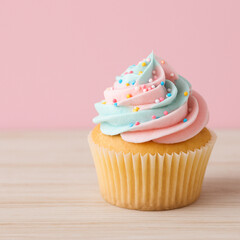 A bttuer cup cake with light pink and blue mix icing cup cake