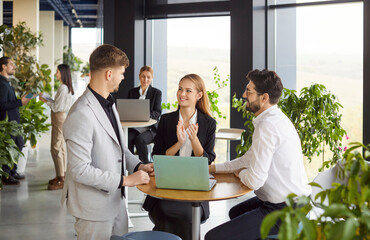 Young people group of company employees talking on business meeting sitting in modern office during...