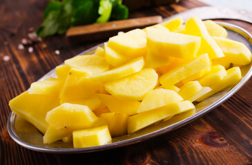 Spiced pieces of raw potato prepared to bake.