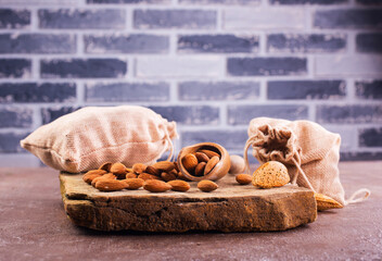 Fragrant roasted almonds with kitchen utensils on a stone table
