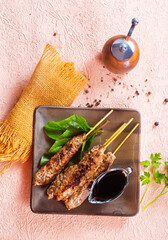 Grilled Lula kebab on skewers with spices in a claim plate on a table