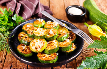 Tasty fried zucchini slices on a plate