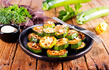 Tasty fried zucchini slices on a plate