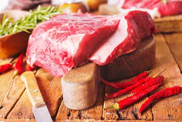 Raw meat on cutting board, with herbs, spices on cooking table top view copy space