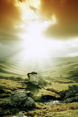 Obraz premium A landscape view of a ruined building on a hill with a bright sky and green rolling hills around it