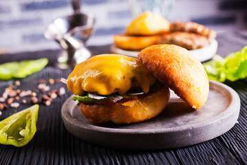 Close up cheese burger on wooden background.