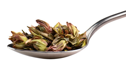 Dried tea leaves on a spoon dark background