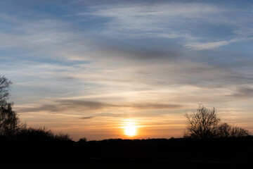 Sunset with a beautiful cloud pattern and a nature silhouette
