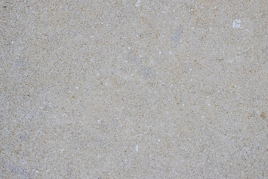 Light gray granular texture imitating asphalt or concrete surface ideal as background for graphic design or photomontage creating minimalist look
