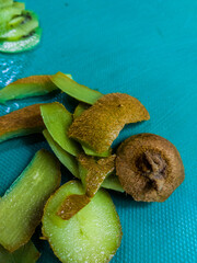 Kiwi fruit peel Slices shot taken in Kitchen on a green Background, photo is selective focus with...