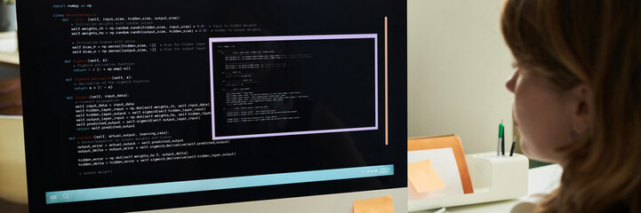 Caucasian young adult woman working on neural network development, analyzing code on computer...