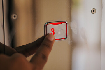 close up of finger pressing 3th floor button in elevator