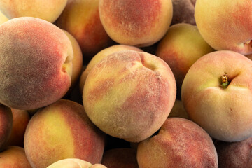 Fresh peaches collected in a vibrant farmers market during late summer harvest season