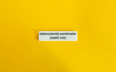 Statcoulomb-Centimeter Unit on Letter Tile Against Yellow Background – Minimalist Science and...