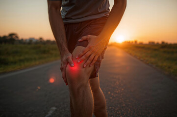 Person Holding Knee in Pain During Outdoor Exercise for Joint Health and Pain Relief Promotion