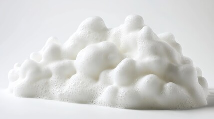 White foam bubbles clustered together on a smooth surface against a plain white background.