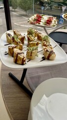 Elegant Filled Crepe Rolls Served on a White Tray at a Buffet