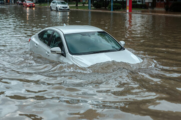 Car Submerged in Flooded City Street for Climate Change and Disaster Relief Campaigns