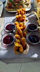 Appetizing Fried Snacks, Crispy French Fries and Cheese Sticks with Sauces for a Buffet