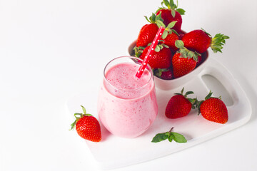 A glass of fresh strawberry smoothie on a white background. Summer drink shake, milkshake and refreshment organic concept.
