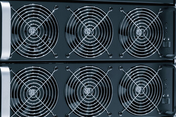 Dark blue computer tower with a large fan on the top. The fans are black and silver. The tower is made of metal