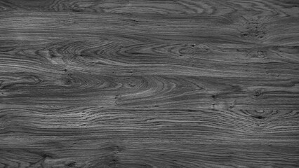 A wooden surface with a grainy texture. The wood is dark and has a natural look. The surface is...