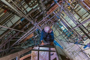 The topview male worker down the ladder is for inspection stainless steel tank