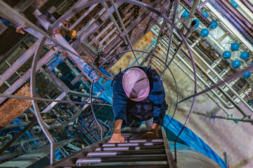 The topview male worker down the ladder is for inspection stainless steel tank