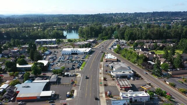 4K drone video showing multiple car dealership buildings, exteriors, with large parking busy lots along SE McLoughlin Blvd in Gladstone, Oregon, USA