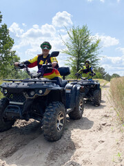 Quad bike ride on dirt roads in nature, vertical shooting
