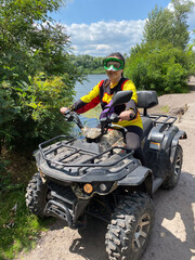 Quad bike ride on dirt roads in nature, vertical shooting