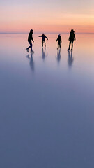 Silhouettes Ice Skating at Sunset: A Serene Winter Activity on a Frozen Lake