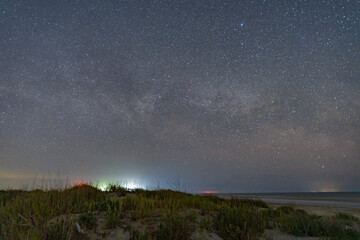 The Milky Way arches above a remote wild beach on the Black Sea coast, captured on a warm summer night free from light pollution – a serene astrophotography scene of stars, sea, and solitude
