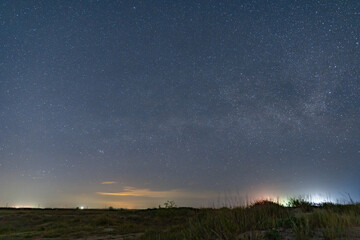 The Milky Way arches above a remote wild beach on the Black Sea coast, captured on a warm summer night free from light pollution – a serene astrophotography scene of stars, sea, and solitude