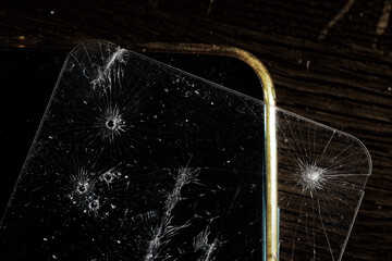 broken glass cracks on smartphone screen on black
