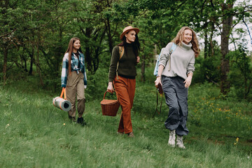 Obraz premium Active middle age woman leading community hike in green forest, promoting fitness, wellbeing, and healthy lifestyle among older women in nature, enjoying wellness and longevity outdoors.