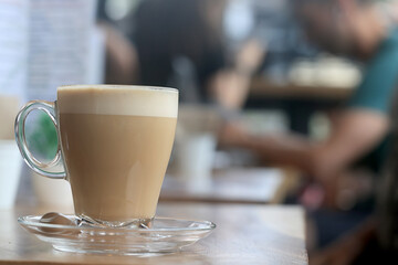 cappuccino, coffee in a clear glass cup in a cafe, soft color background food and drink, hot drink