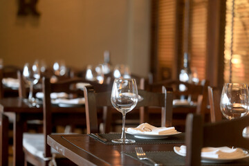 table setting in the restaurant, glasses and cutlery, a clean new table in the restaurant is...