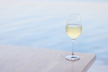 Wine glass close-up in real life, beautiful blurred background of the drink in the glass