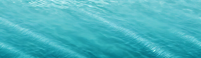 Obraz premium Clear turquoise water surface with sun reflections – tropical sea background