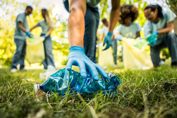 Group of volunteer cleaning picking up plastic litter in the park - Diverse group of people collect trash in the forest - Environmental protection, non profits organization and save the planet concept