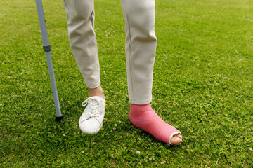  Man with broken leg in plaster during football match - injury of young athlete 