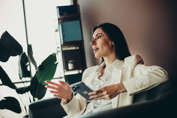 Successful businesswoman in formalwear discussing ideas in a modern office environment