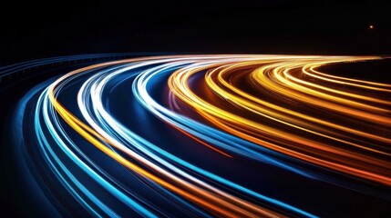 Fototapeta premium Abstract image of curving roads at night, with streaks of light from moving vehicles