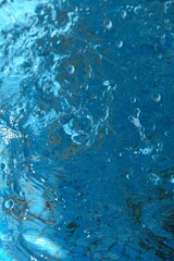 Blue transparent sea surface with bubbles water background