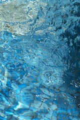Blue transparent sea surface with bubbles water background