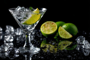 Fototapeta premium Fresh cocktail served in a martini glass with lime twist